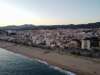 Aerial view of townscape by city against clear sky