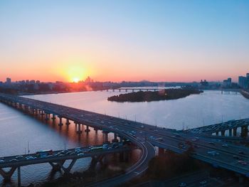 High angle view of bridge over river against sky during sunset