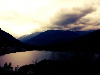 Scenic view of lake against cloudy sky