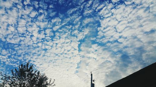 Low angle view of building against cloudy sky