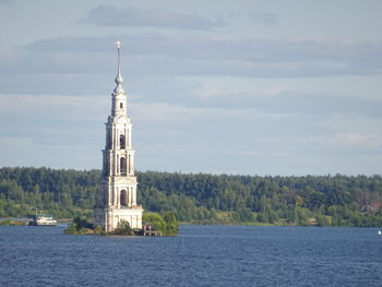 Tower by building against sky