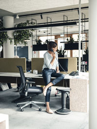 Female entrepreneur talking on telephone at office