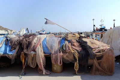 Fishing nets at harbor against clear sky