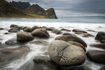 Rocks in sea against sky