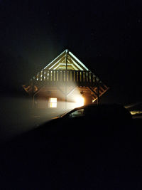 Illuminated building against sky at night