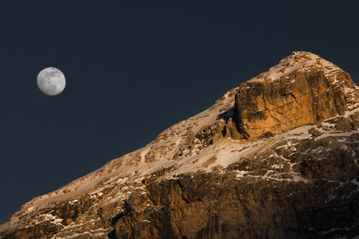 Low angle view of rock formation against clear sky at night