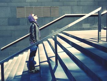 Side view of man standing on staircase