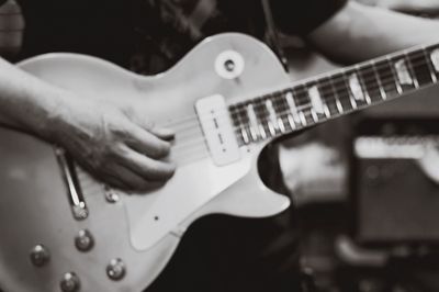 Close-up of hands playing guitar