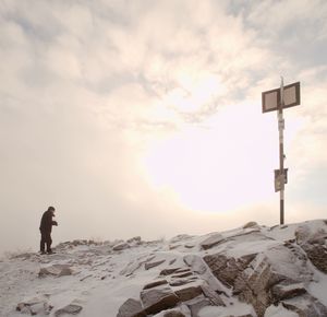 Photographer takes picture of freeze autumnal daybreak. stony rock peak increased from thick mist.