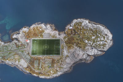 Soccer field on the cliffs of henningsvær by the sea