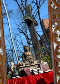 Low angle view of statue against bare trees