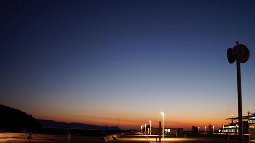 Low angle view of illuminated lights against sky at night