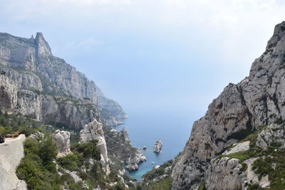 Scenic view of sea and mountains against sky