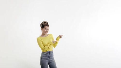 Portrait of a smiling young woman against white background