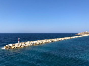 Scenic view of sea against clear blue sky