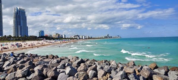 Panoramic view of sea and buildings against sky