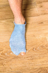 Low section of man legs on hardwood floor