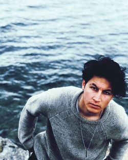 High angle portrait of man standing against sea