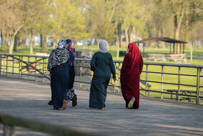 Rear view of women walking on street