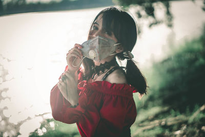 Portrait of woman drinking water