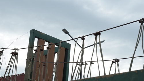 Low angle view of silhouette bridge against sky