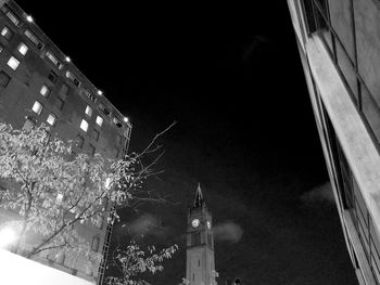 Low angle view of skyscraper against sky at night