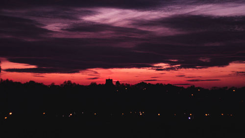 Silhouette trees against sky at night