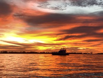 Scenic view of sea against orange sky