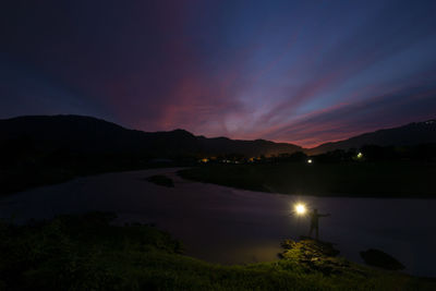 The evening landscape, the river, the mountains, the dark blue sky, and my shadow holding