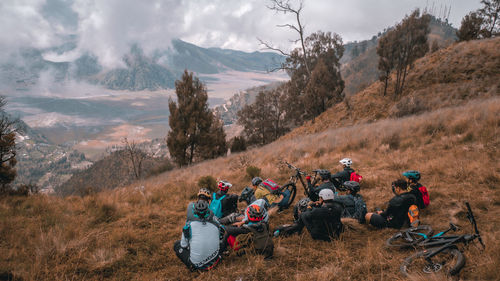 People on field against mountains