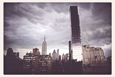 Buildings against cloudy sky