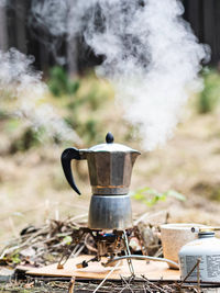 Making coffee outdoors in a metal coffee pot