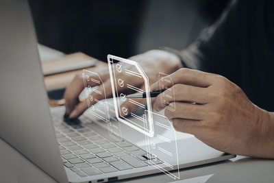 Midsection of woman using laptop