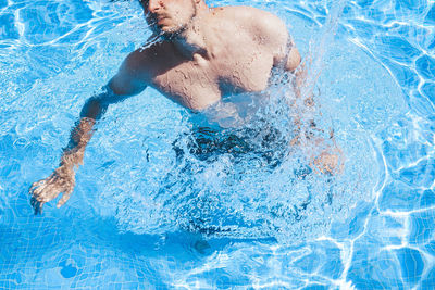 High angle view of man swimming in pool