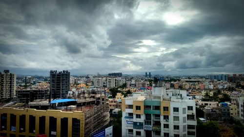 Cityscape against cloudy sky