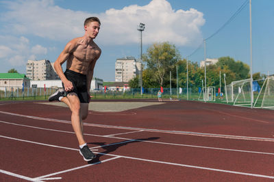 Full length of man exercising on road