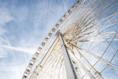 Low angle view of ferris wheel against blue sky