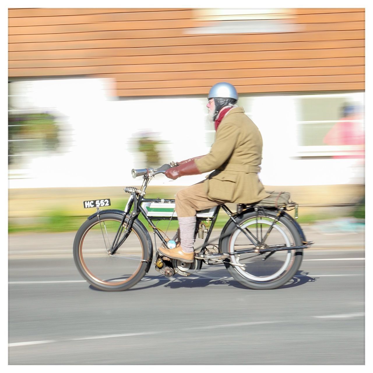 MAN RIDING BICYCLE ON ROAD