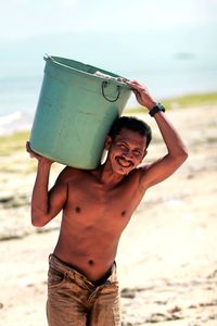 Portrait of shirtless boy standing at beach