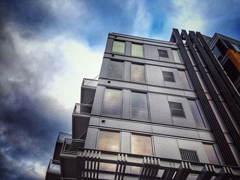 Low angle view of building against cloudy sky