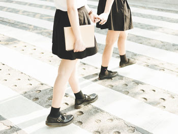 Low section of friends crossing road