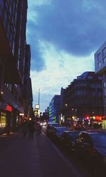 Illuminated city street at dusk