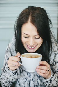 Young woman with cup of coffee