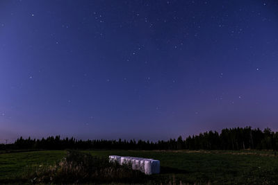 Scenic view of field against sky at night