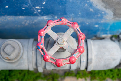 Close-up of red chain hanging on land