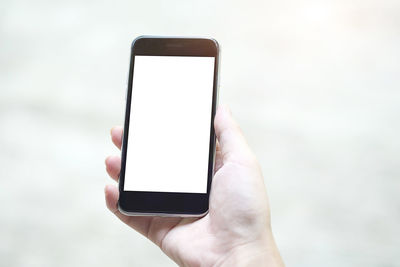 Close-up of hand holding mobile phone