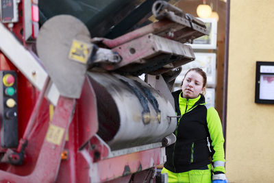 Woman operating garbage truck