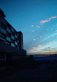 Low angle view of silhouette buildings against sky at sunset