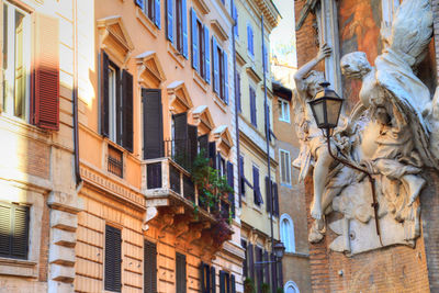 Low angle view of statue against building in city