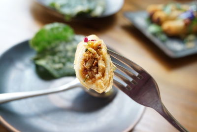 High angle view of food in fork at table